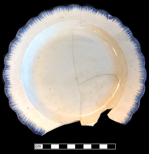 Shell edge pearlware plate, neoclassical rim. Rim diameter:  7.00”. Lots: 8 and 9, Proveniences 1G3.869.46 and 1G2.457.16, Privy Stratum 2
 18BC38